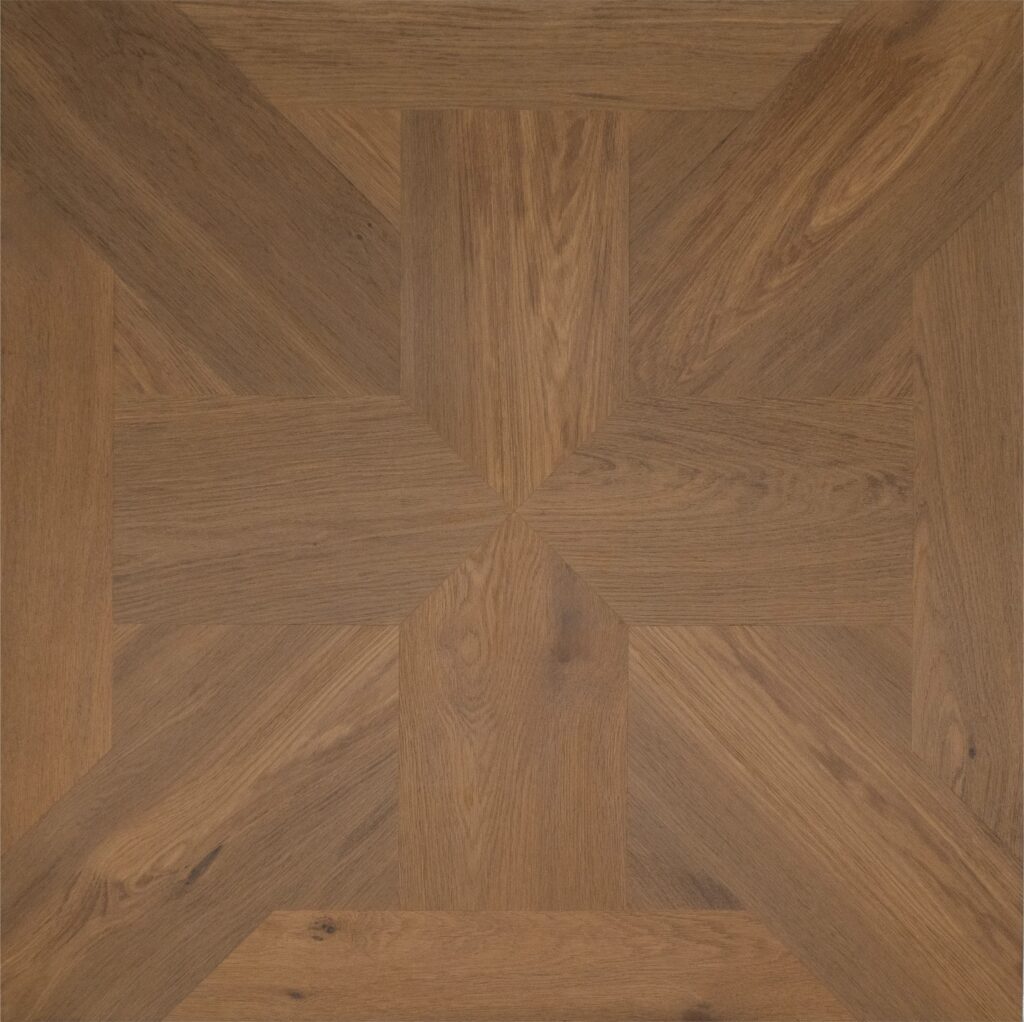A close-up view of a geometric wood parquet floor pattern in warm medium brown tones with visible natural wood grain.