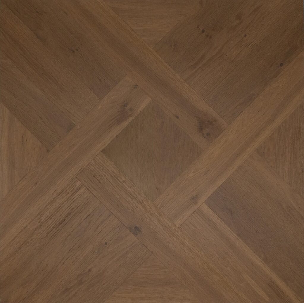 Medium brown wood flooring with a geometric parquet pattern showing natural wood grain and knots.